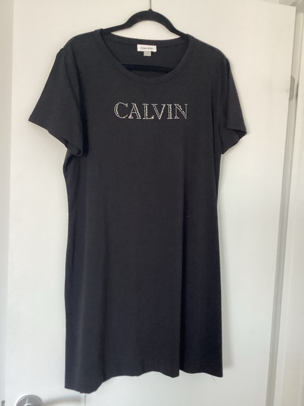 Calvin Klein Black Tee with Branded Neck Label. This is a dress.